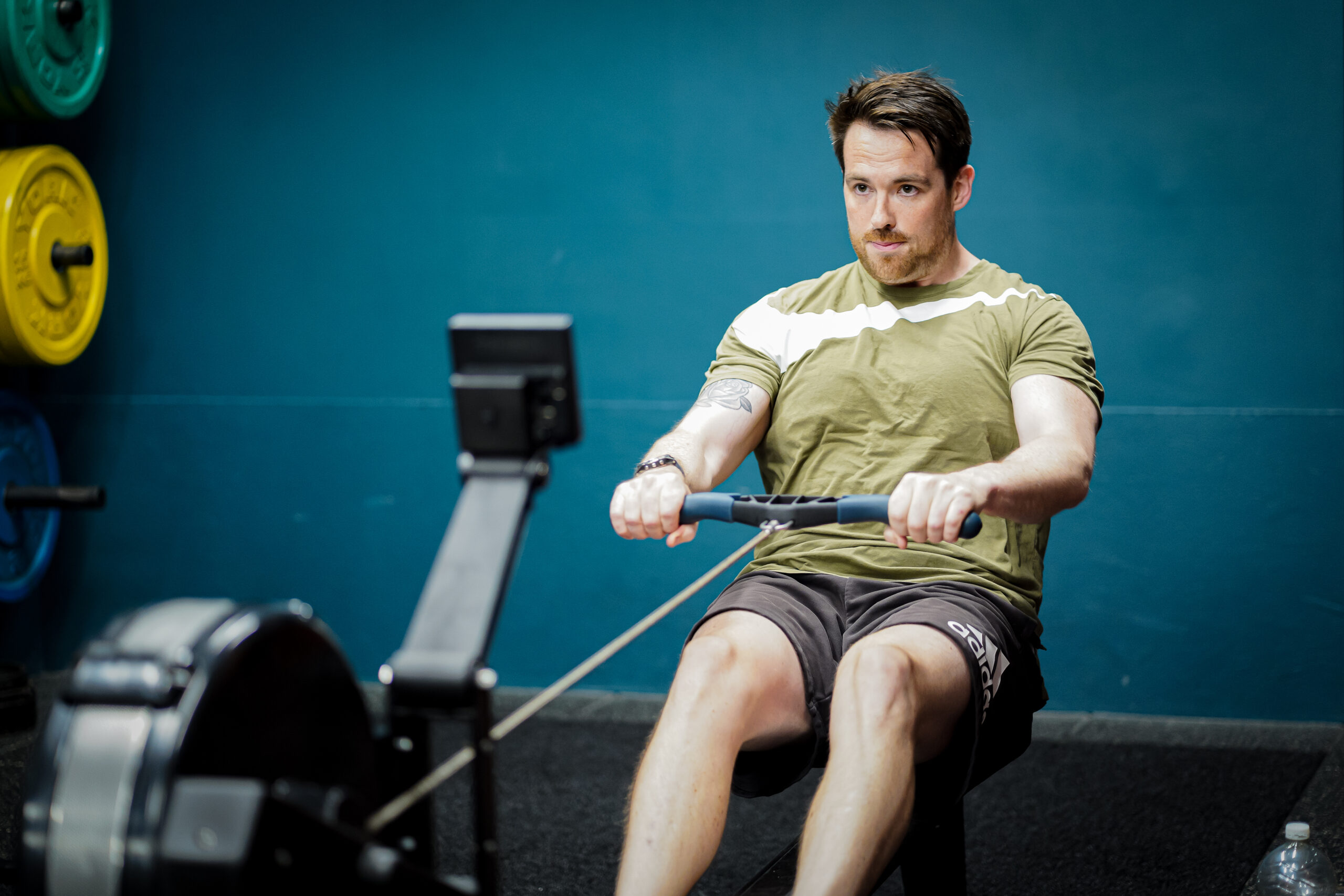 A member on the rower during a coached session