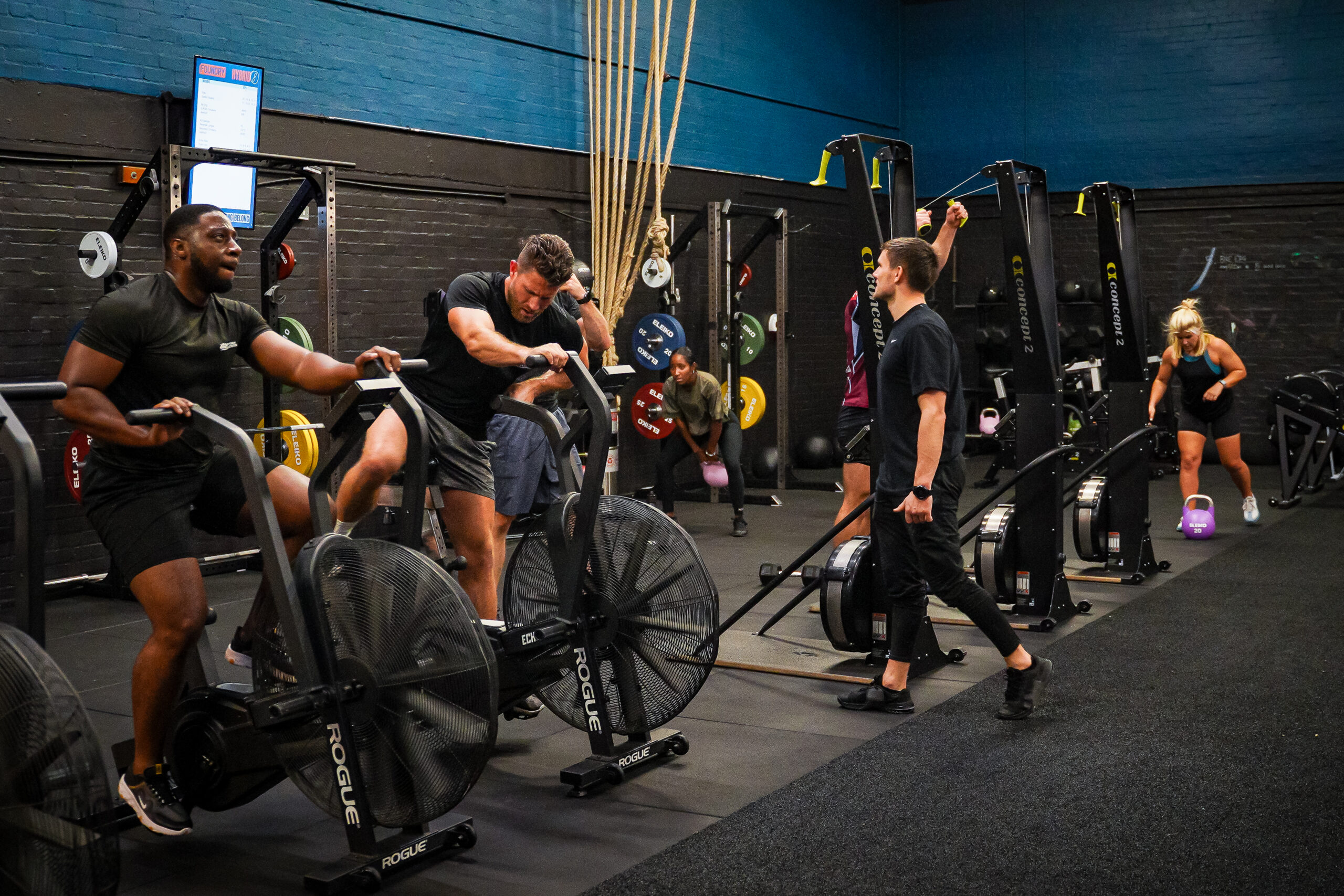 A coached small-group session — bikes, a coach, six people